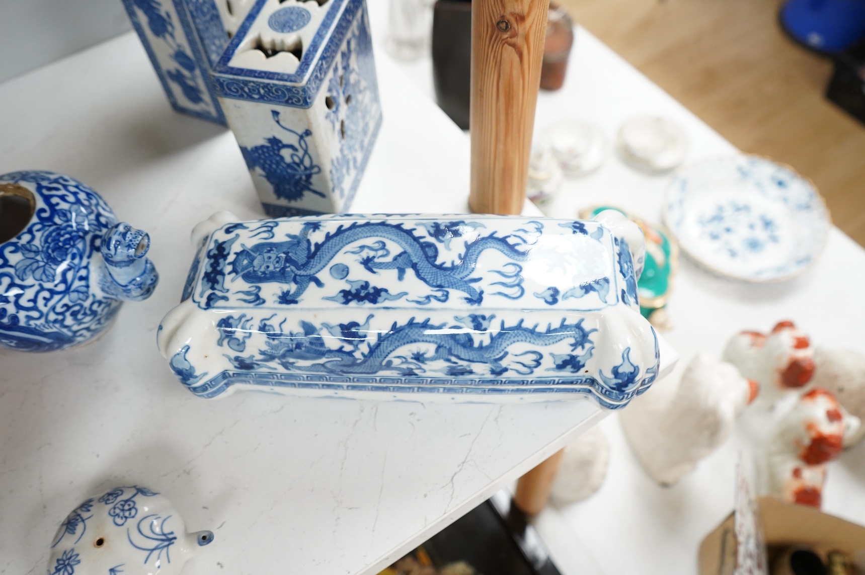 A group of Chinese blue and white comprising a dish and cover, two pillows, waterdropper and a teapot, largest 26cm wide